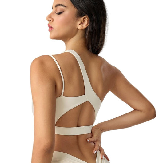 Easelyn Asymmetric One-Shoulder Sports Bra in cream, back view