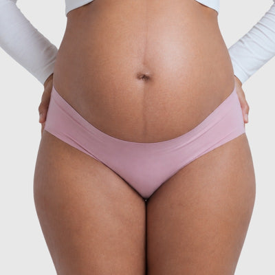 Easelyn Seamless Maternity Briefs — 5 Pack in pink, front view under the bump