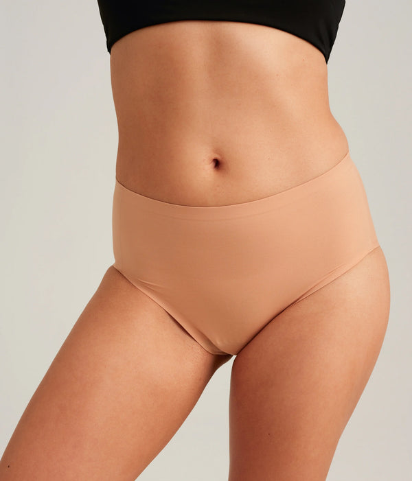 Easelyn Leakproof Seamless High-Waist Period Brief in smooth terracotta, front view on model