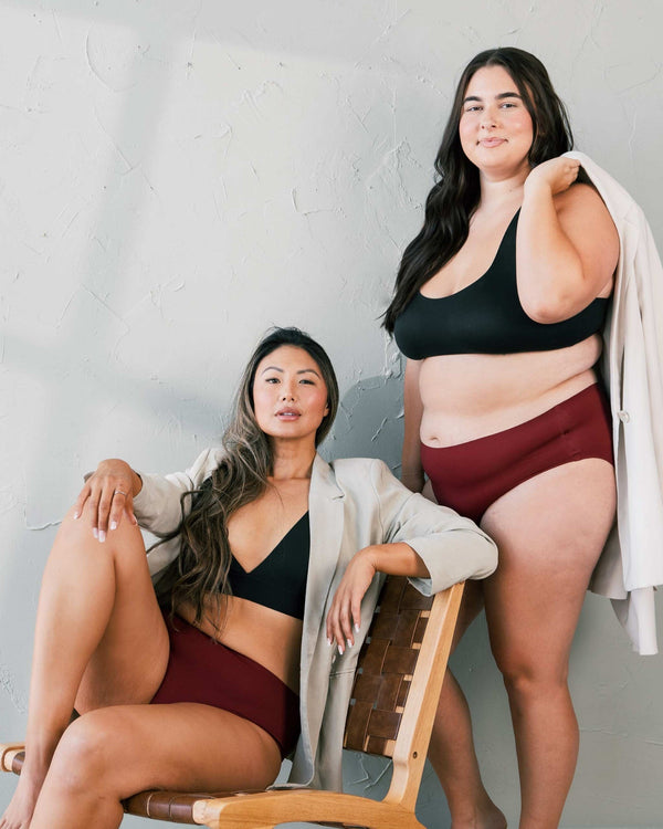 Easelyn Leakproof Seamless High-Waist Period Brief in crimson rose, two women of different sizes wearing the brief in a relaxed studio lifestyle shot