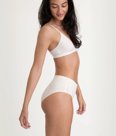 Easelyn Leakproof Seamless High-Waist Period Brief in soft sand, side view on model showing the high rise