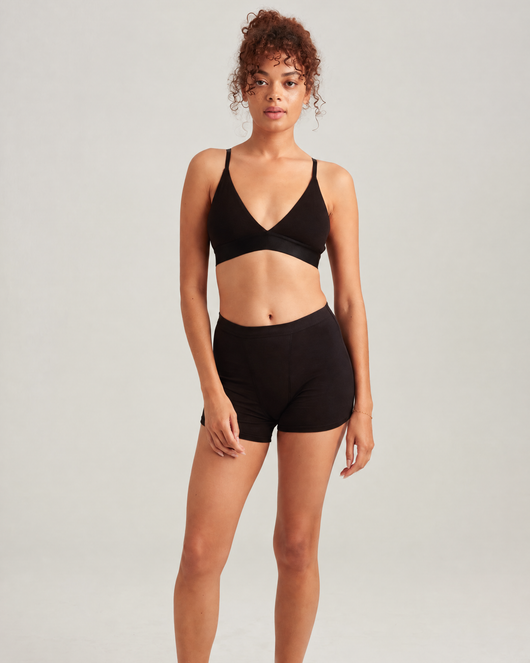 Easelyn Overnight Leakproof Sleep Short in volcanic black, full-length front view on model
