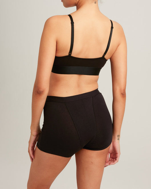 Easelyn Overnight Leakproof Sleep Short in volcanic black, back view on model showing the full rear coverage