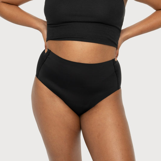 Easelyn Smoothing High-Waist Leakproof Brief in black, front view on model showing the high smoothing waistband