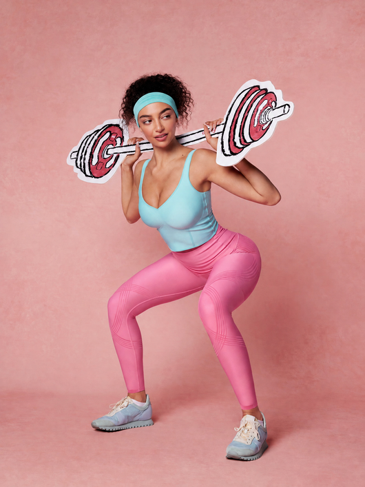 Easelyn Butt-Lifting Sculpt Leggings in sugar pink, playful squat with a cartoon barbell on a pink backdrop