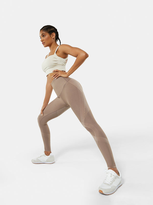 Easelyn Butt-Lifting Sculpt Leggings in tan, side lunge showing the stretch