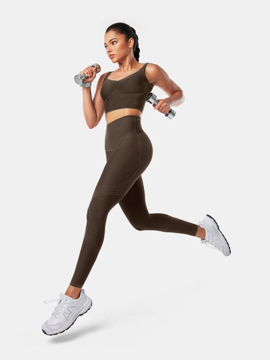 Easelyn Butt-Lifting Sculpt Leggings in chocolate brown, running with light dumbbells