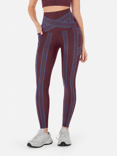 Easelyn Built-In Resistance Band Leggings in Cherrywood/Malibu Blue, front view from the waist down showing the malibu blue band lines, crossover waistband and side pocket