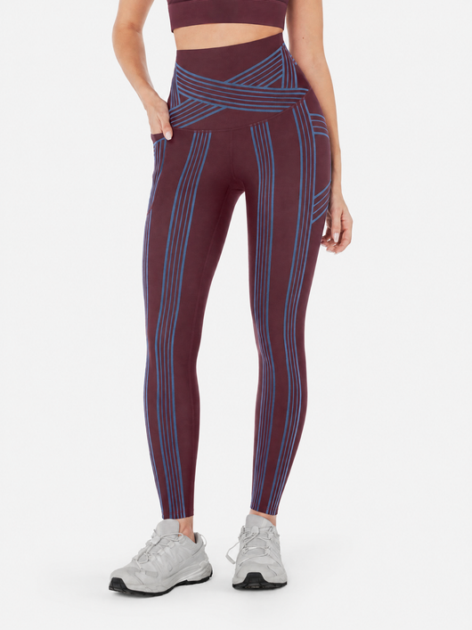 Easelyn Built-In Resistance Band Leggings in Cherrywood/Malibu Blue, front view from the waist down showing the malibu blue band lines, crossover waistband and side pocket