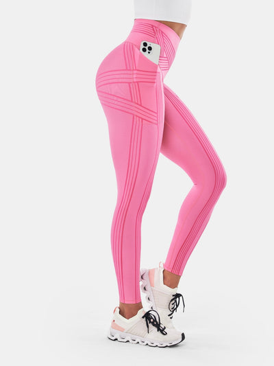 Easelyn Built-In Resistance Band Leggings in Sugar Pink, side view from the waist down with a phone in the side pocket and band lines across the hip