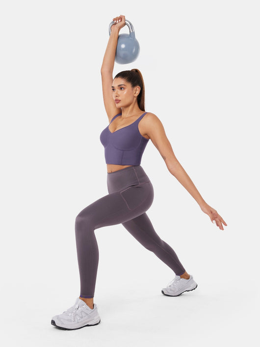 Easelyn Built-In Resistance Band Leggings in Cloud Gray/Aurora Violet, full-body lunge holding a kettlebell overhead, solid reverse side