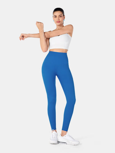 Easelyn Built-In Resistance Band Leggings in Power Blue, full-body front view stretching one arm, solid reverse side