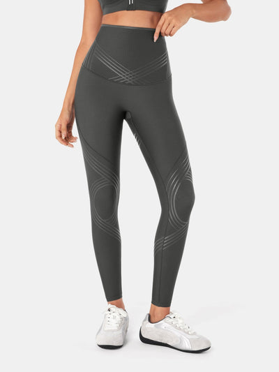 Easelyn Postpartum Recovery Compression Leggings in Dark Gray, front view from the waist down with a hand at the top of the high waistband