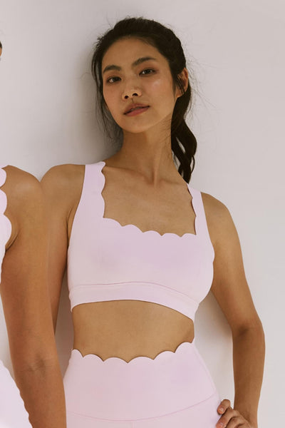 Easelyn Classic Cross-Back Sports Bra in Ballet Blush, front close-up of the scalloped square neckline and wide straps