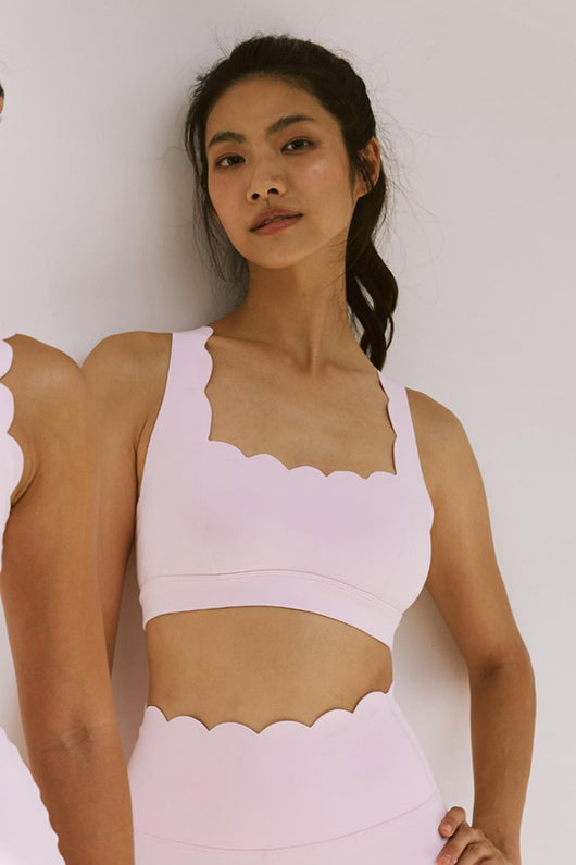 Easelyn Classic Cross-Back Sports Bra in Ballet Blush, front close-up of the scalloped square neckline and wide straps