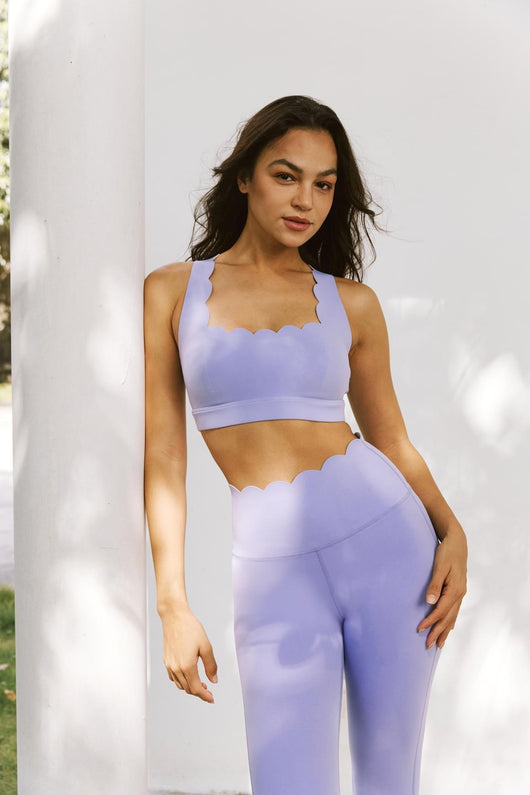 Easelyn Classic Cross-Back Sports Bra in Lavender Frost, standing front view against a white pillar