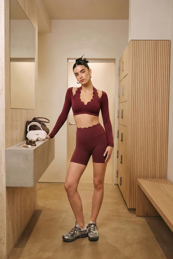 Easelyn High-Waist Scrunch Biker Shorts in Mulled Wine, full-length front view in a locker room