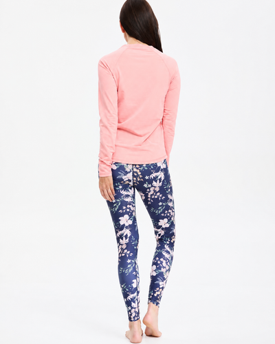 Easelyn UPF 50+ High-Rise Swim Leggings in Tropical Navy Floral, full-length back view styled with a pink long-sleeve top