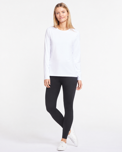 Easelyn UPF 50+ Long-Sleeve Sun Shirt in White, full-length front view styled with black leggings and white sneakers