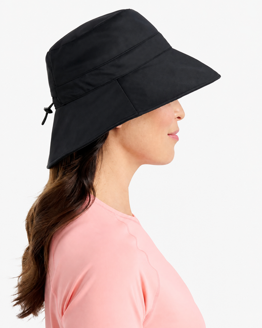 Easelyn UPF 50+ Wide-Brim Sun Hat in Black, side profile on model showing the wide brim and back toggle cord