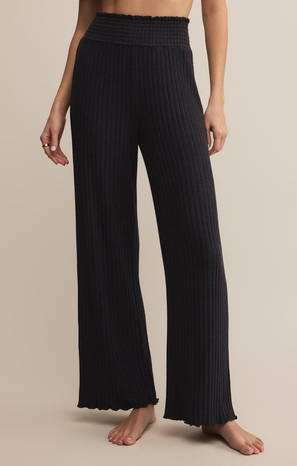 Easelyn Smocked-Waist Rib Flare Lounge Pant in Black Sand, front view from the waist down showing the smocked waistband and wide flared leg
