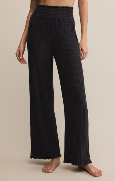 Easelyn Smocked-Waist Rib Flare Lounge Pant in Black Sand, front view from the waist down showing the smocked waistband and wide flared leg