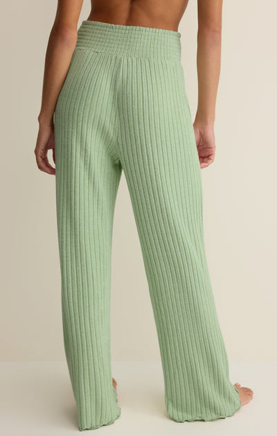 Easelyn Smocked-Waist Rib Flare Lounge Pant in Pistachio, back view from the waist down showing the smocked waistband all the way around